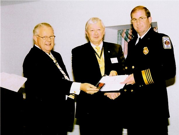 Tom Speelman (middle) presenting Chief Mastin (right) the Fire Safety Award. Larry McKinley read the citation.