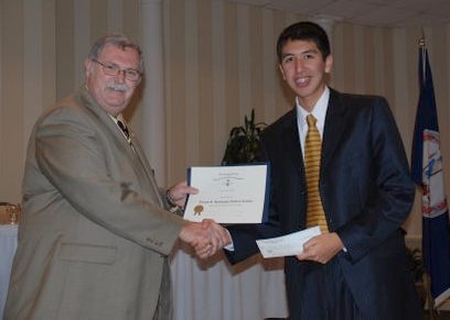 Wayne McClelland presents Mr. Barrientos with a certificate and a check for his state winning oration.