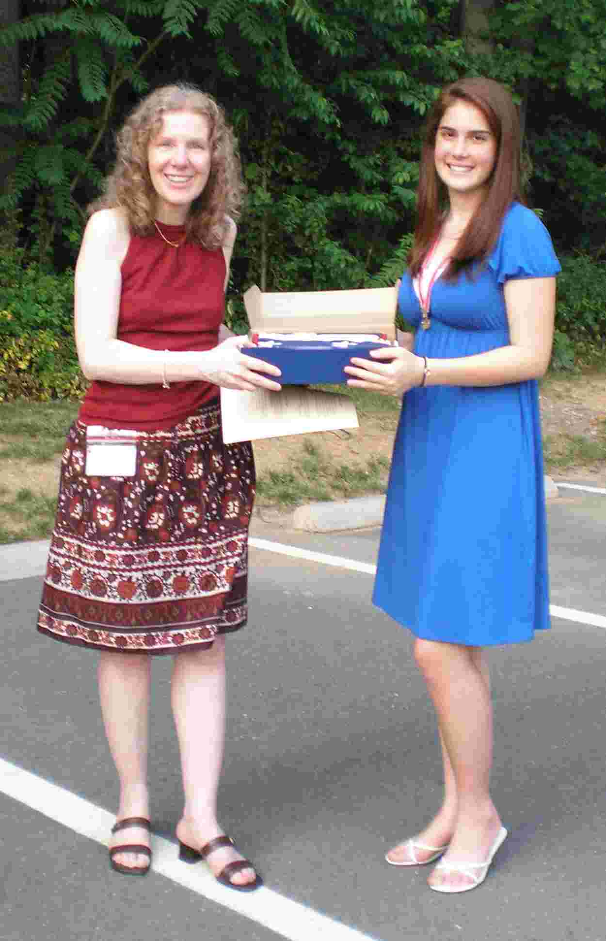 Martina Caputy presents a new flag to Linden Renner