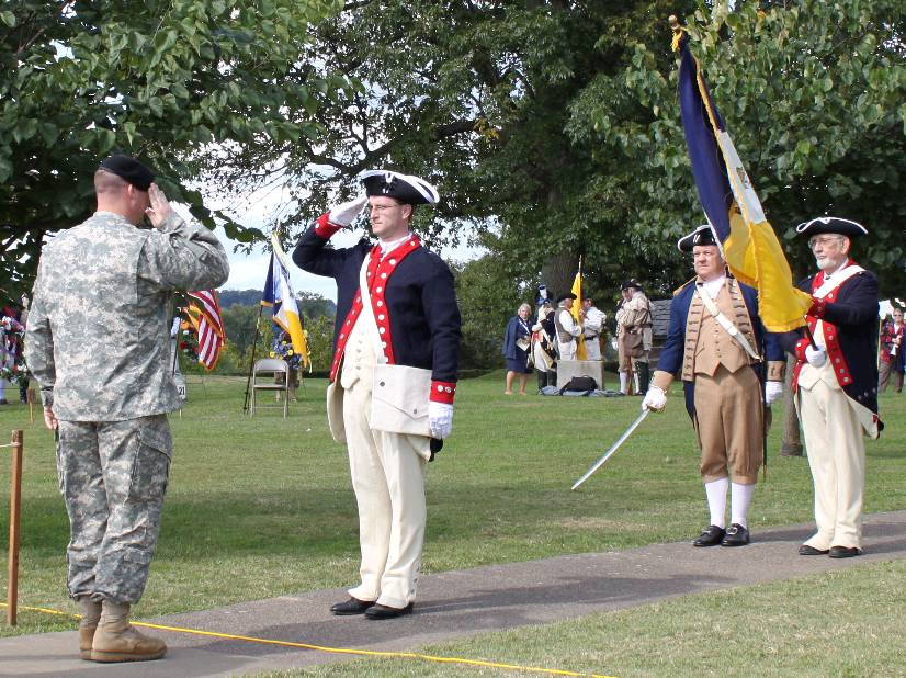 Compatriot Darrin Schmidt and the Honor Guard salute in recognition of the sacrifices of our ancestors