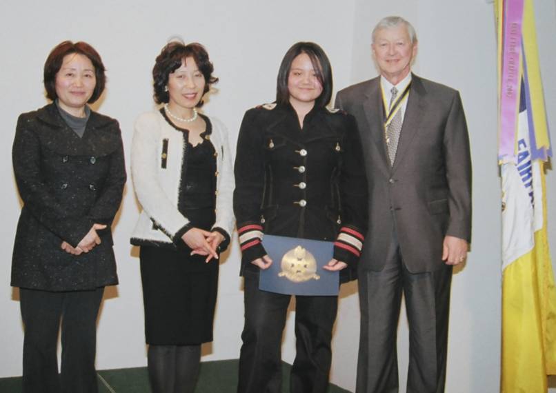 Ms. Clark poses with her family (left) and Chapter President Tom Speelman (right).