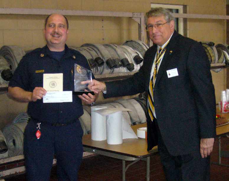 Chapter President Jack Sweeney presents Lieutenant Matthew P. Malof with the VASSAR award and a check for $500