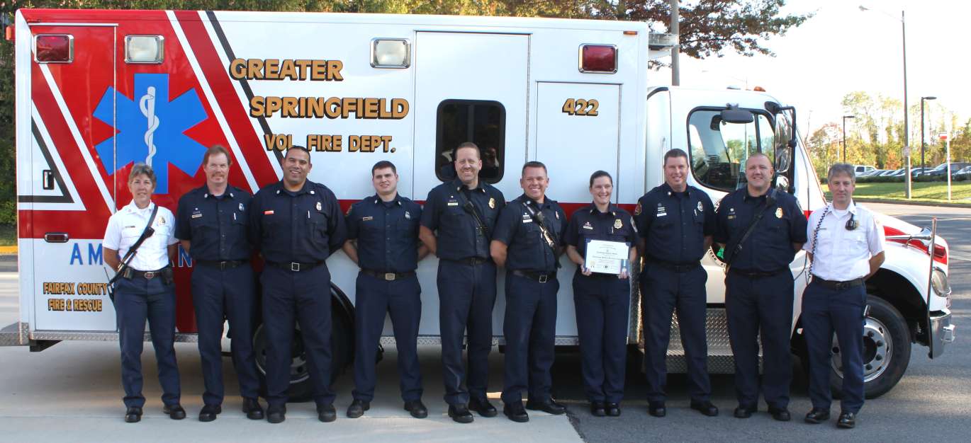 Lieutenant Jennifer Svites displays her award with the rest of her team in front of the medical unit.