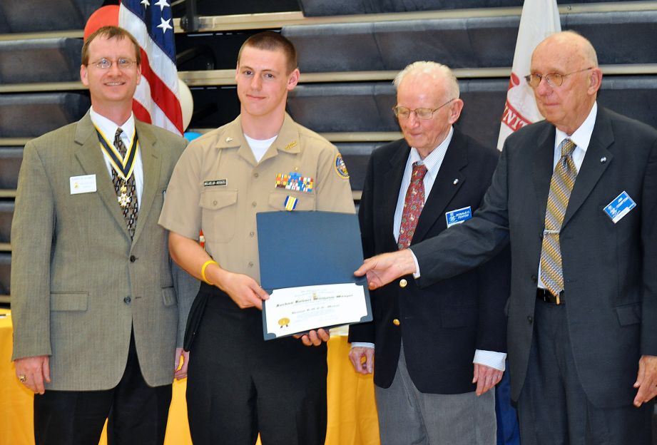 Compatriots Darrin Schmidt (left), Don Fenton, and Jim Compton (right) present the SAR JROTC Medal to Cadet Jordan Willhelm-Wenzel at Loudoun High School on 1 June, 2011.