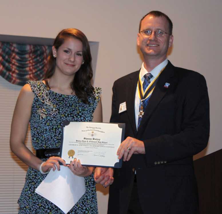 Chapter President Darrin Schmidt presents Ms. Bishop with the award for her winning essay
