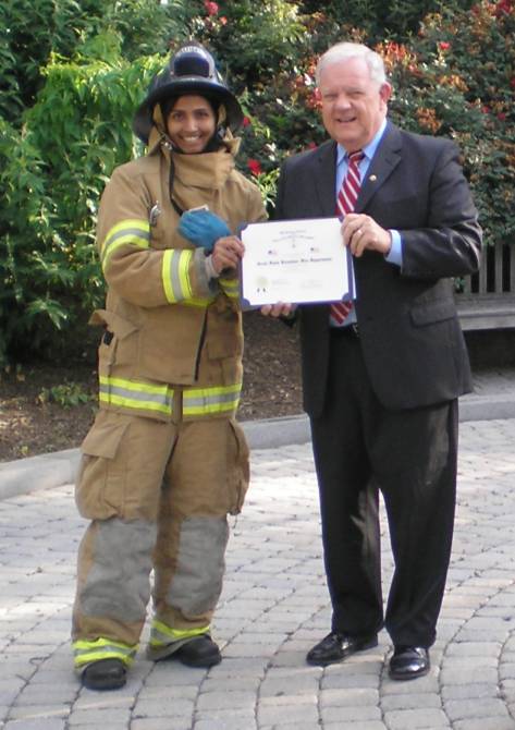 Compatriot Larry McKinley presents an SAR flag certificate to the Great Falls Fire House for their properly display of the flag in the Great Falls community.