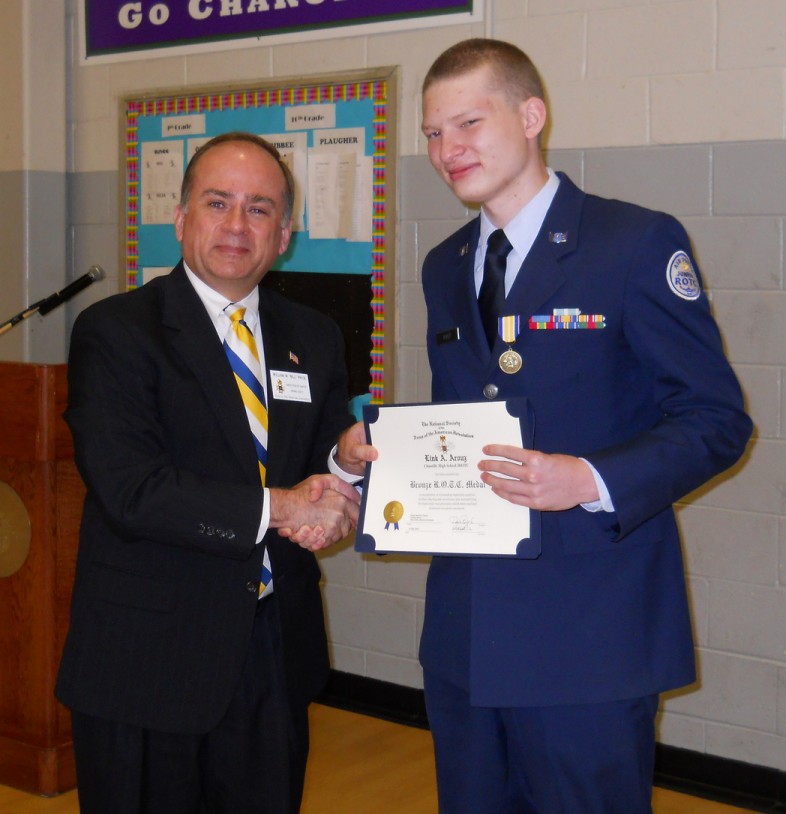 Compatriot Bill Price presents the SAR JROTC Medal to Cadet Link Arouz at Chantilly High School on 12 May, 2012.