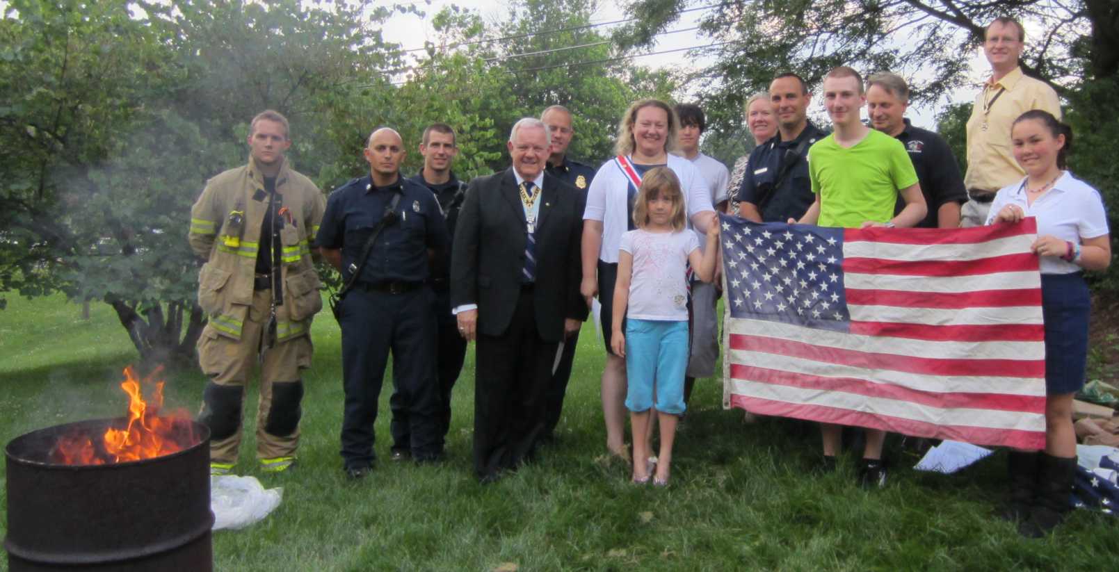 Attendees pose for a picture before beginning the process of retiring the flags.