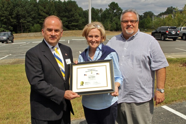 Compatriot Bill Price presents a flag certificate to Grace Academy