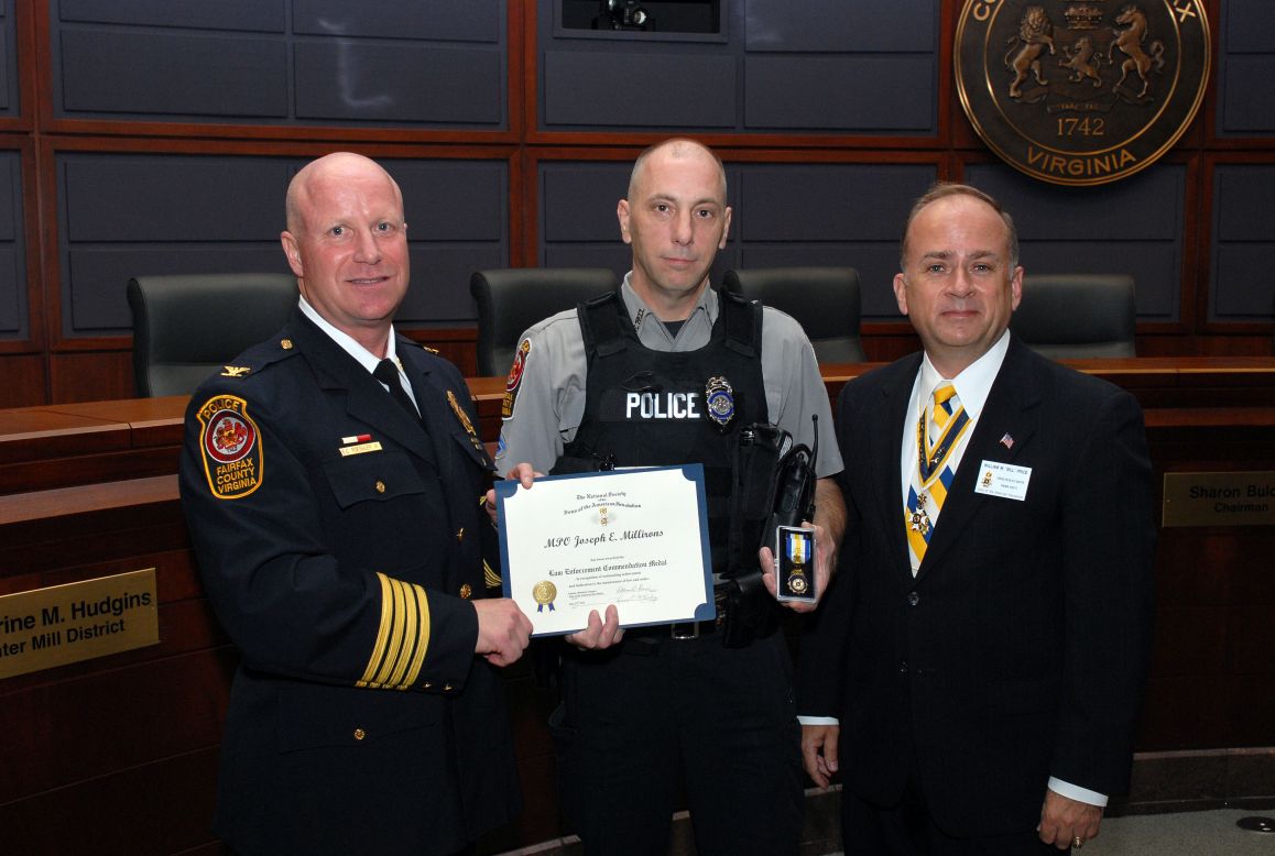 MPO Joseph E. Millirons receives the Law Enforcement Commendation Medal from President Bill Price.