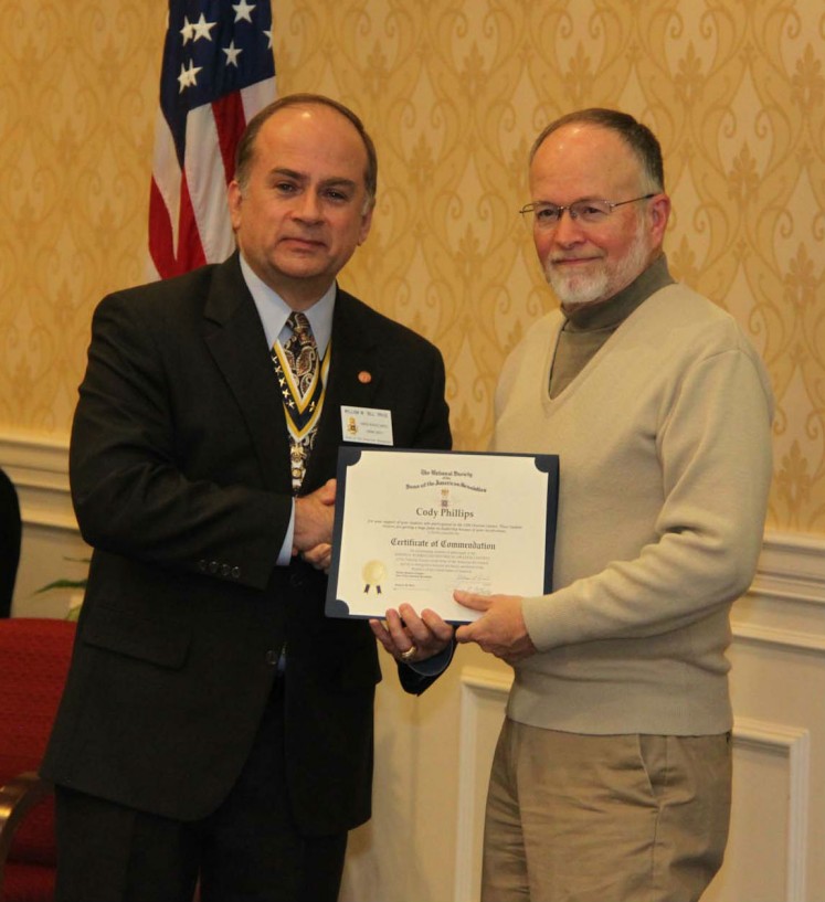 Compatriot Bill Price presents a Certificate of Appreciation to Mr. Cody Phillips in acknowledgement of his support for the Rumbaugn Orations Contest.