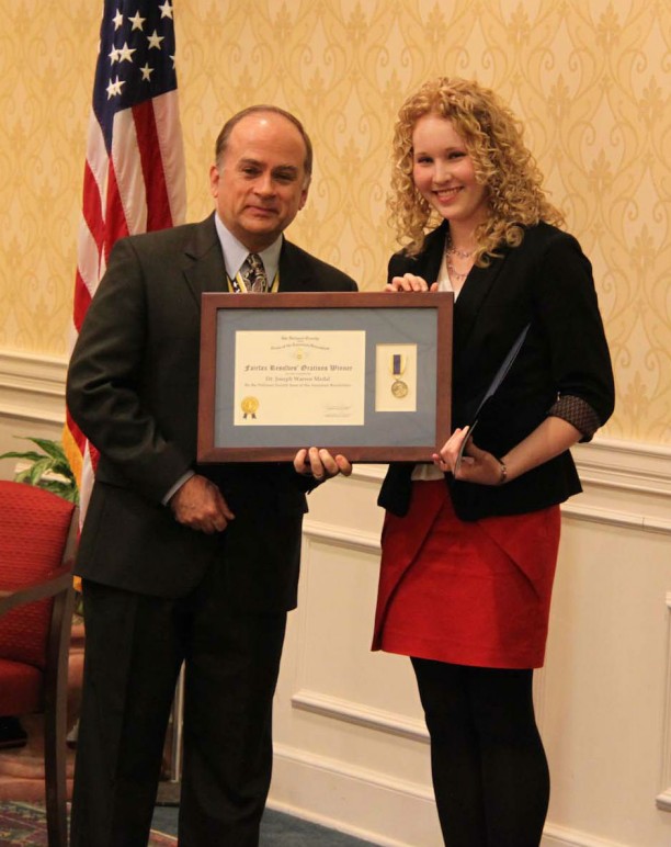 Compatriot Bill Price presents the Joseph Warren Medal and first place certificate to Miss Hayley Snowden at the January chapter meeting.