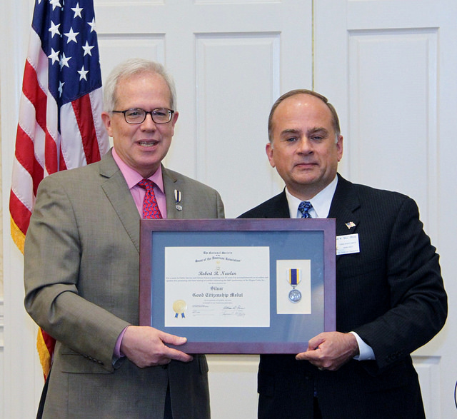 President Bill Price presents Robert R. Newlen with the Silver Good Citizenship Medal