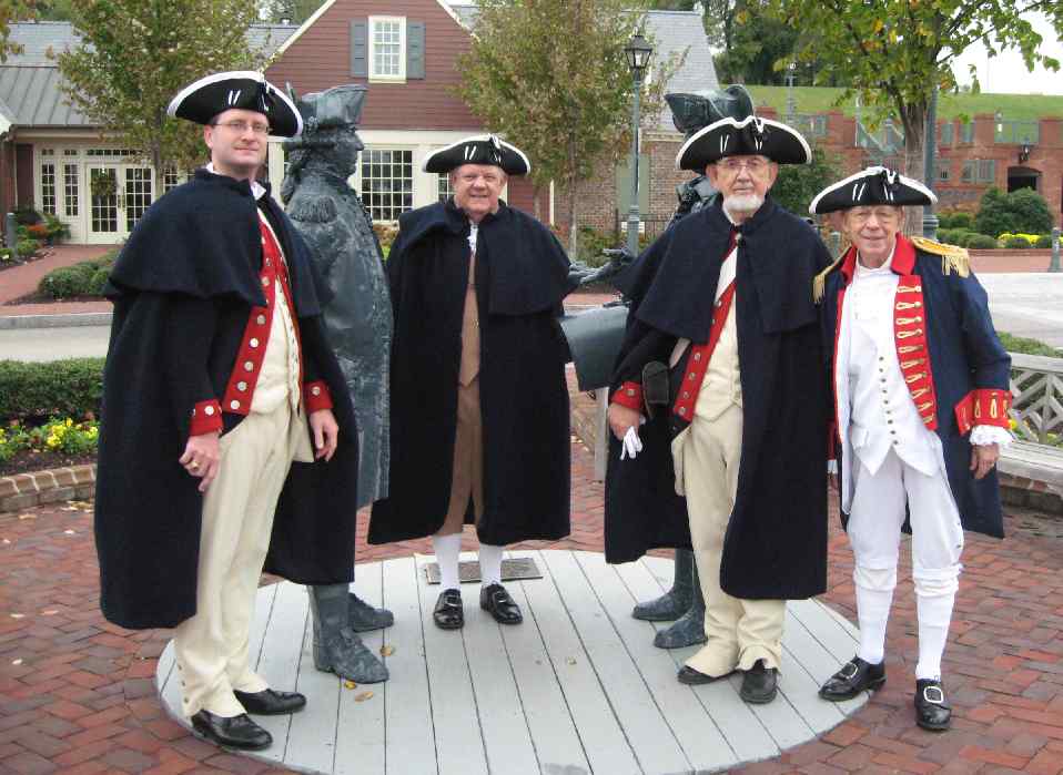 VASSAR Guardsment Darrin Schmidt, Larry McKinley, Andy Johnson, and Trice Taylor pause for a picture with their bronze Compatriots on the Yorktown waterfront prior to the grave marking.