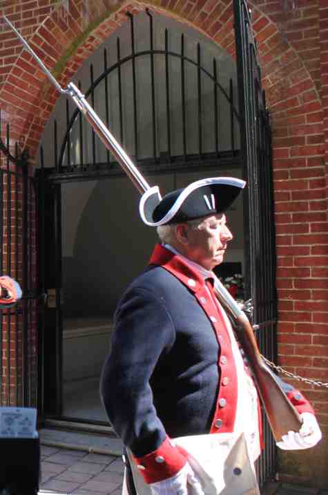 Vernon Eubanks leads the Colorguard unit away from the tomb carrying his Brown Bess musket.