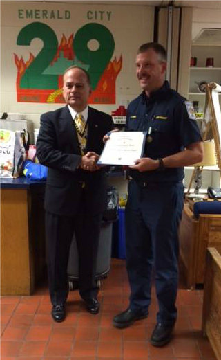 President Bill Price presents Lieutenant David Myers with the Emergency Medical Services Commendation Medal