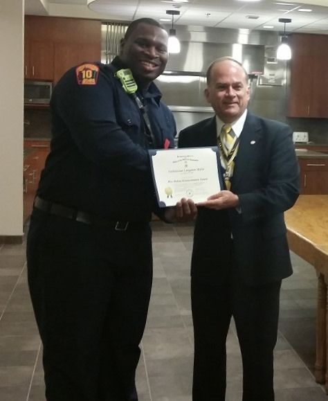 President Bill Price presents Technician Langston Malin with the Fire Safety Commendation Medal