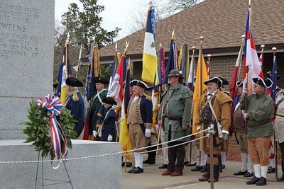 Virginia Color Guard Commander Larry McKinley stands with the Virginia Color Guard flag at the Cowpens Battlefield ceremony.