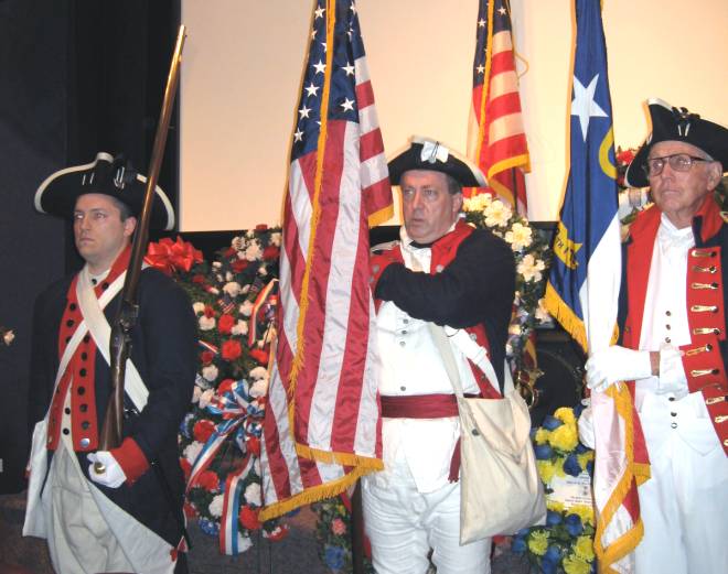 Dan Rolph with his Brown Bess musket (left) presenting the Colors.