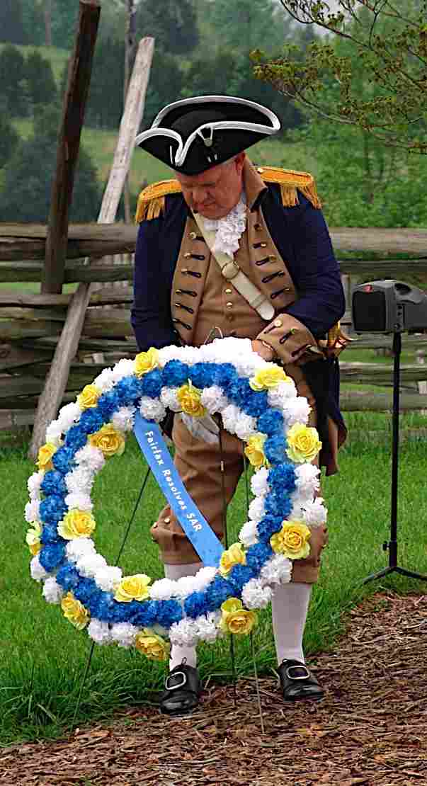 Compatriot Larry McKinley positions the Fairfax Resolves wreath at the monument of General Joseph Martin