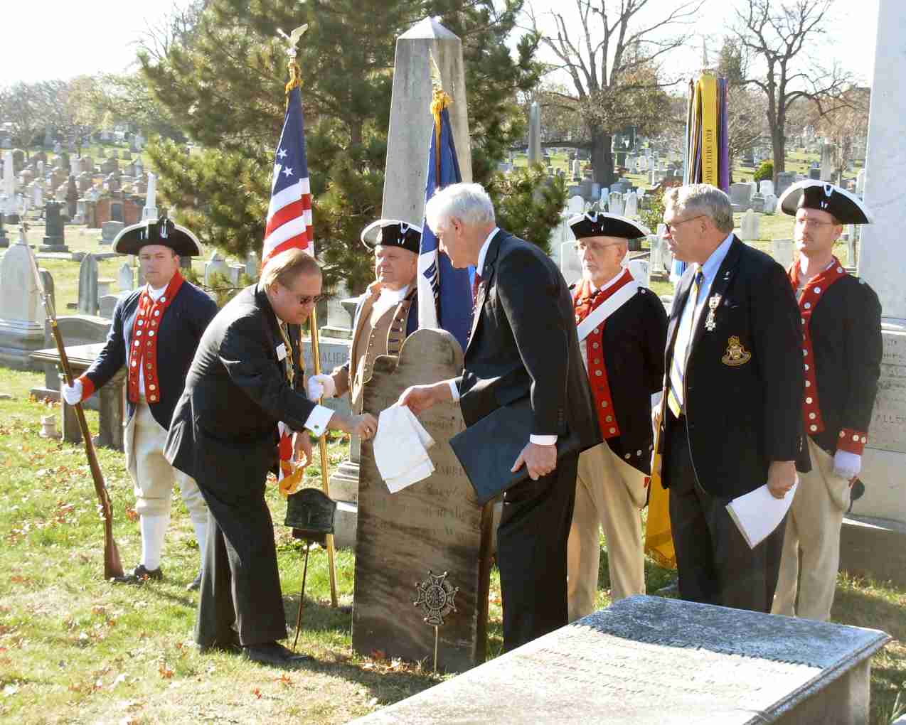 President General David Appleby (left) and Fairfax Resolves Chapter 1st VP Larry Lamborn unveil the SAR Memorial Marker as Jack Sweeney (right) looks on.