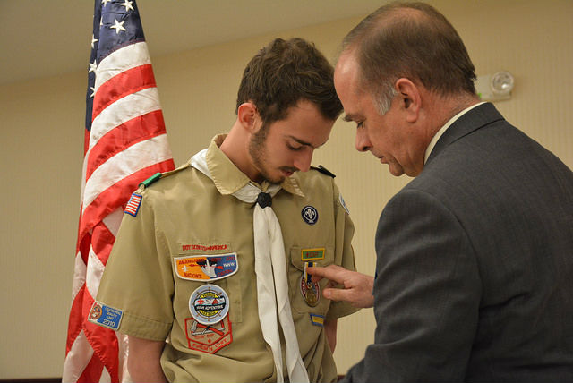President Bill Price pins the Eagle Scout Medal on Mr. Toole's scout uniform