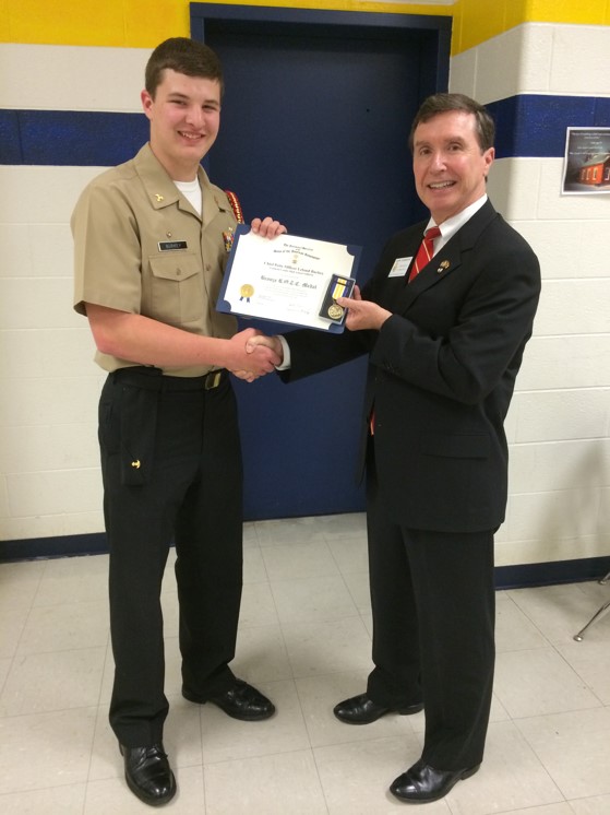 Compatriot Mark Anderson presenting the SAR JROTC Medal to Cadet Burkey at Loudoun County High School on 29 May, 2014.