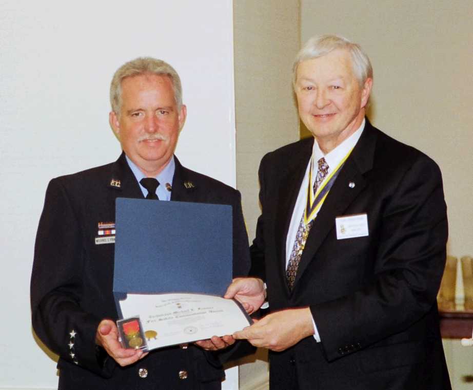 Tom Speelman presents Technician Michael L. Frames with the Fire Safety Award