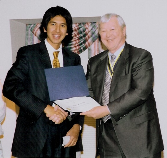 President Speelman presents Gabriel Barrientos with a check for his winning oration.