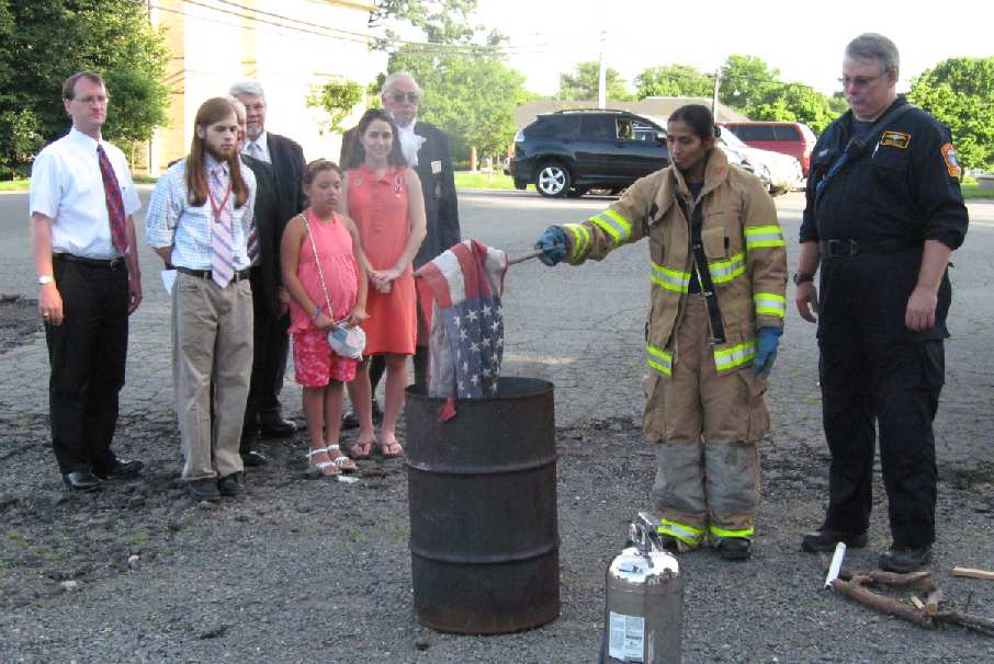 SAR, C.A.R, and volunteer fire fighters retire worn flags.