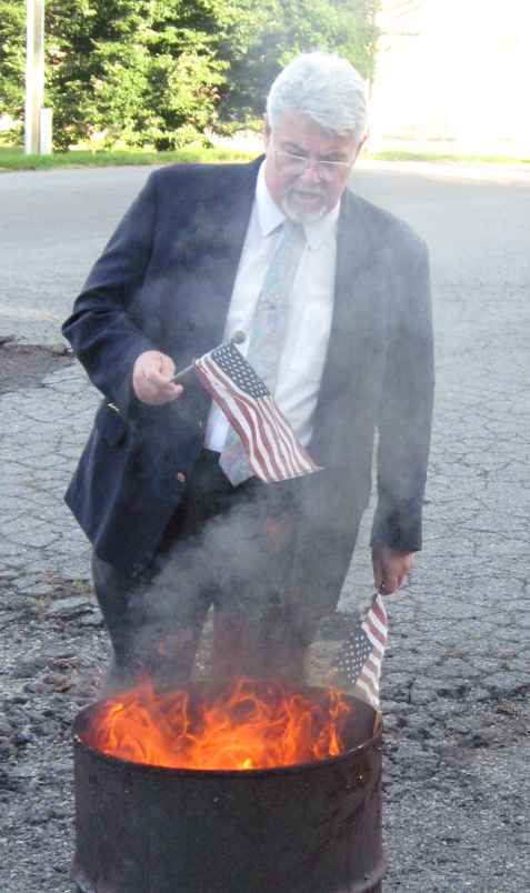 John Sinks retires the flag that was flown over his ancestor’s grave, Benjamin Peachee.