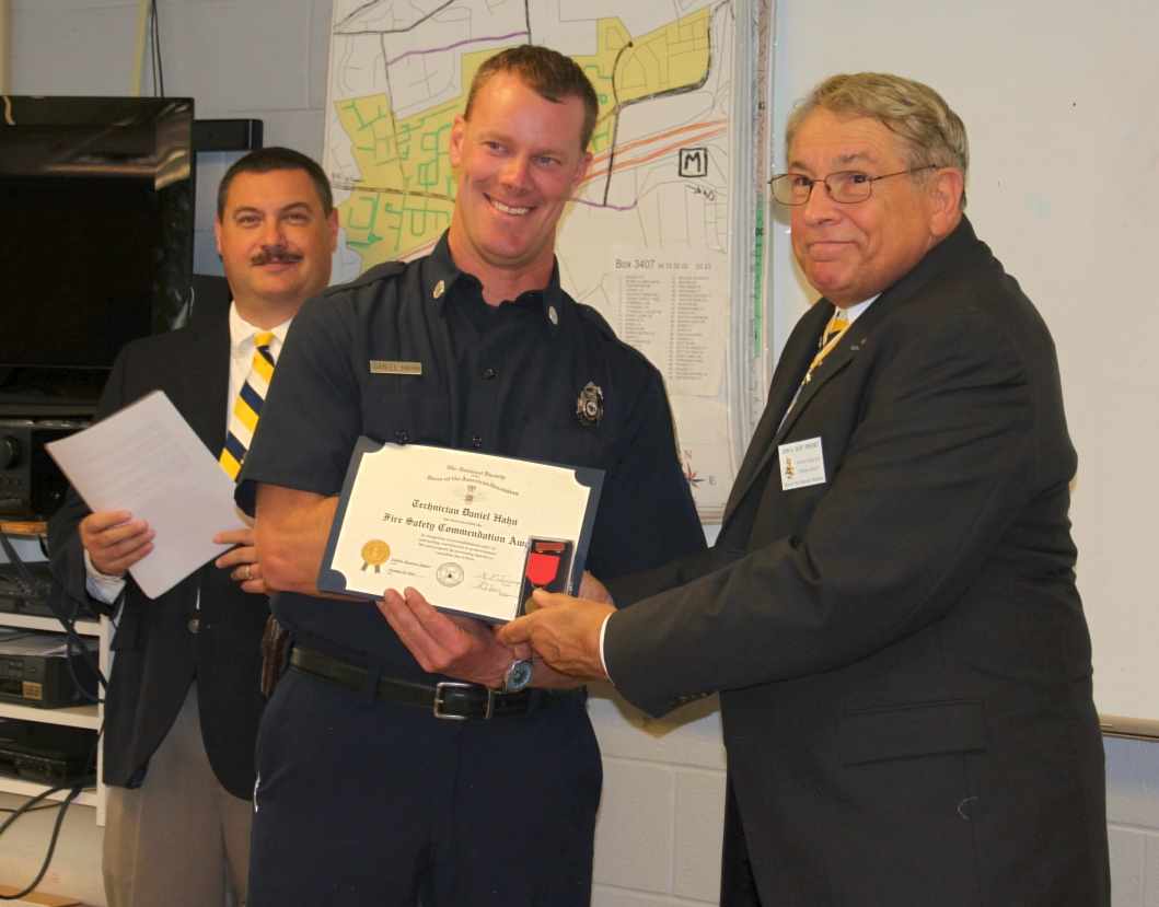 Dan Hahn receives the Fairfax Resolves Fire Safety award from Chapter President Jack Sweeney while Award Chairman Andrew Monahn looks on