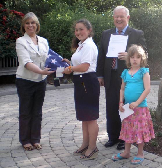 Members of the C.A.R. present the new flag to the Great Falls library. This continues to be a tradition of the event.