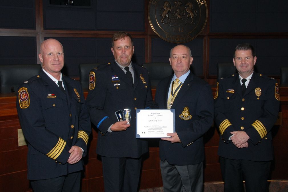 President Phil Ray presents the Law Enforcement Commendation Medal to Sergeant David J. Kuhar.