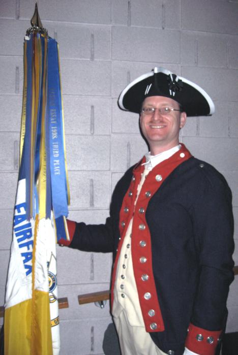 Darrin Schmidt poses with the Fairfax Resolves Flag.