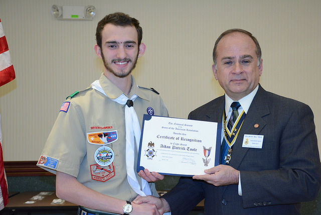 President Bill Price presents Mr. Toole with a certificate and check. The photos were taken March 17 at a Troop 913 Court of Honor 